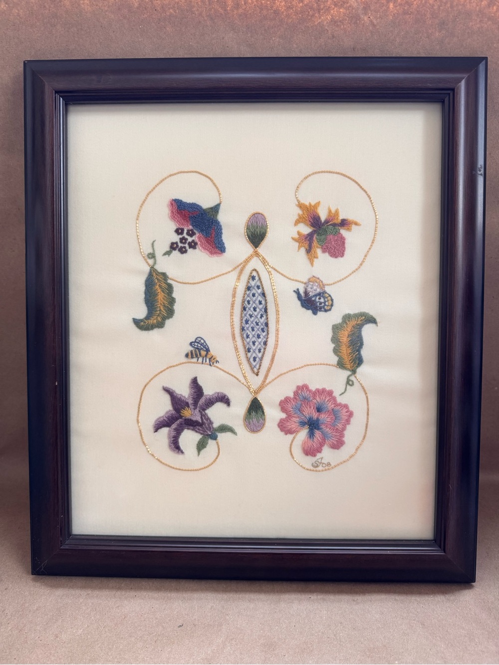 Handmade Crewel Embroidery Featuring Insects and Flora. 2008 in wood frame.
